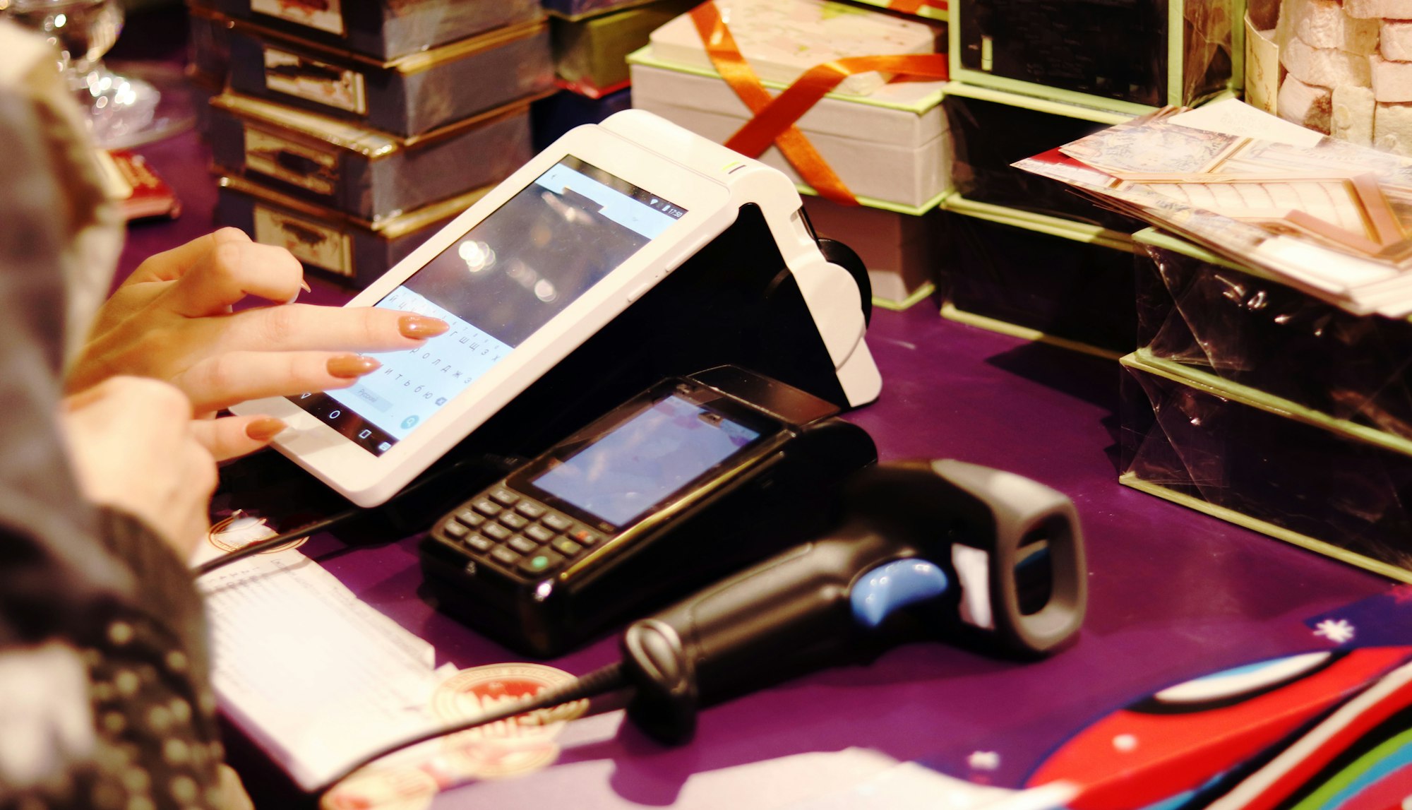 The seller scans the barcode of the goods from the store